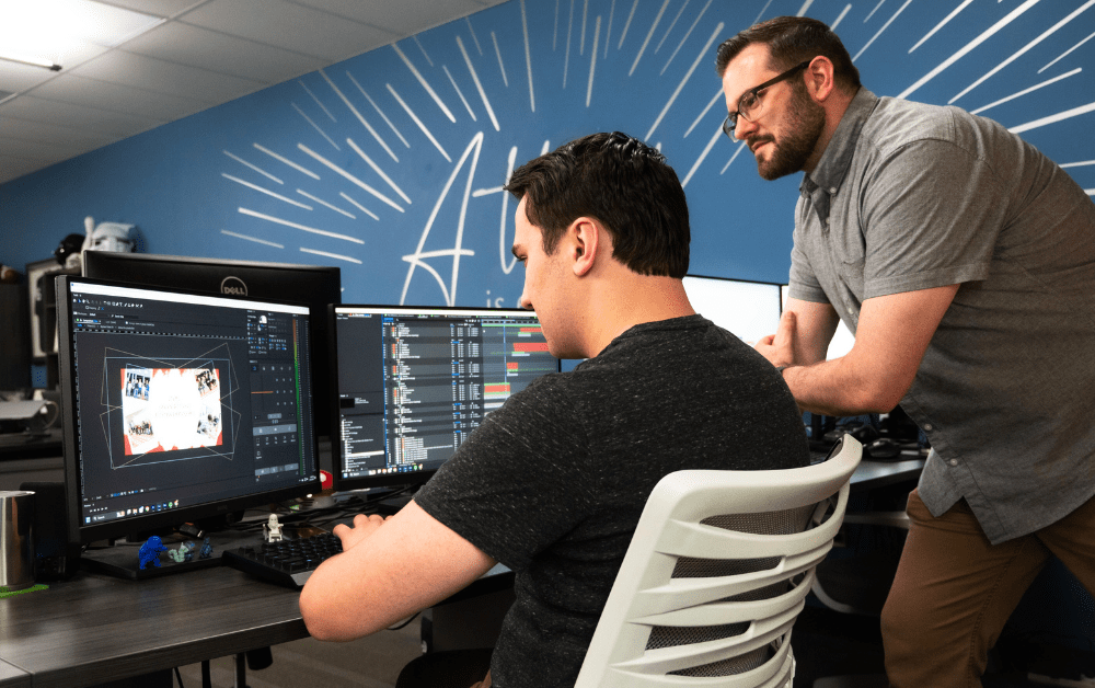 Video marketing team gathered at a computer
