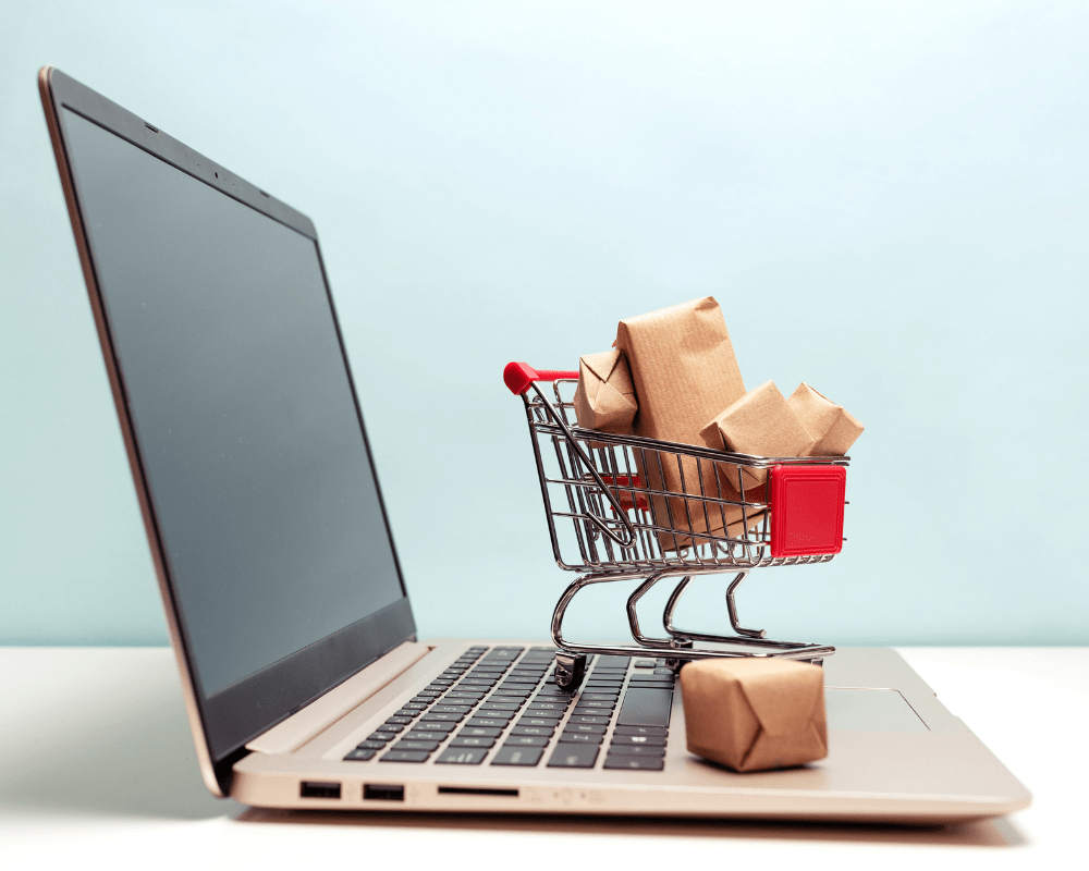 laptop and cart showing digital marketing campaigns