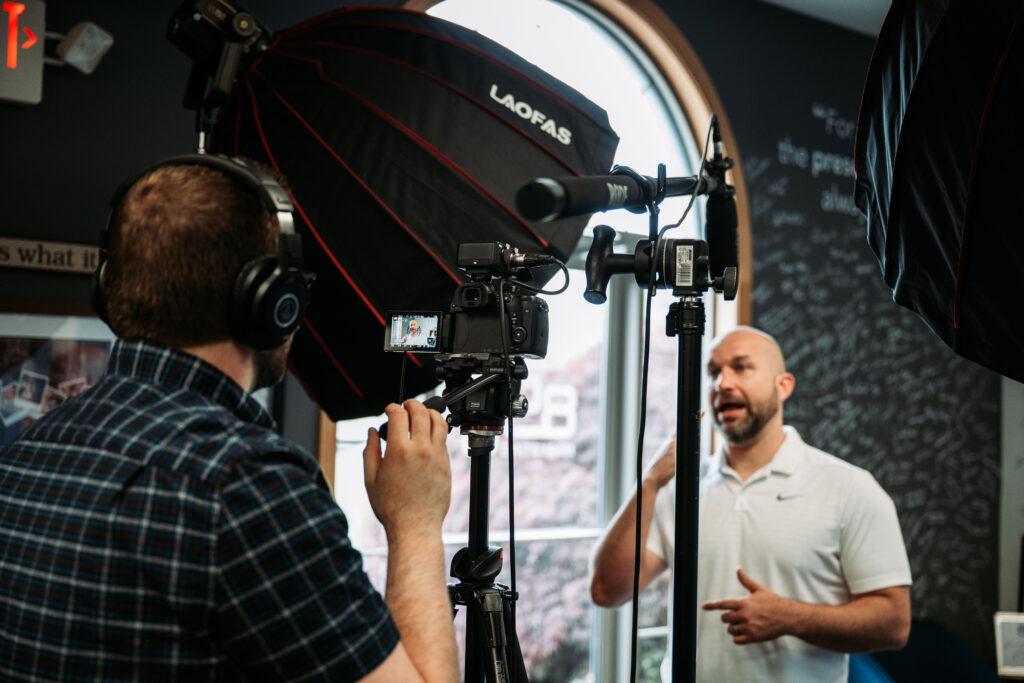 Man filming another man, marketing team filming